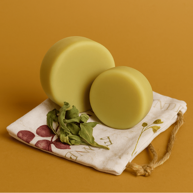 women applying a bar of solid-conditioner to her hair