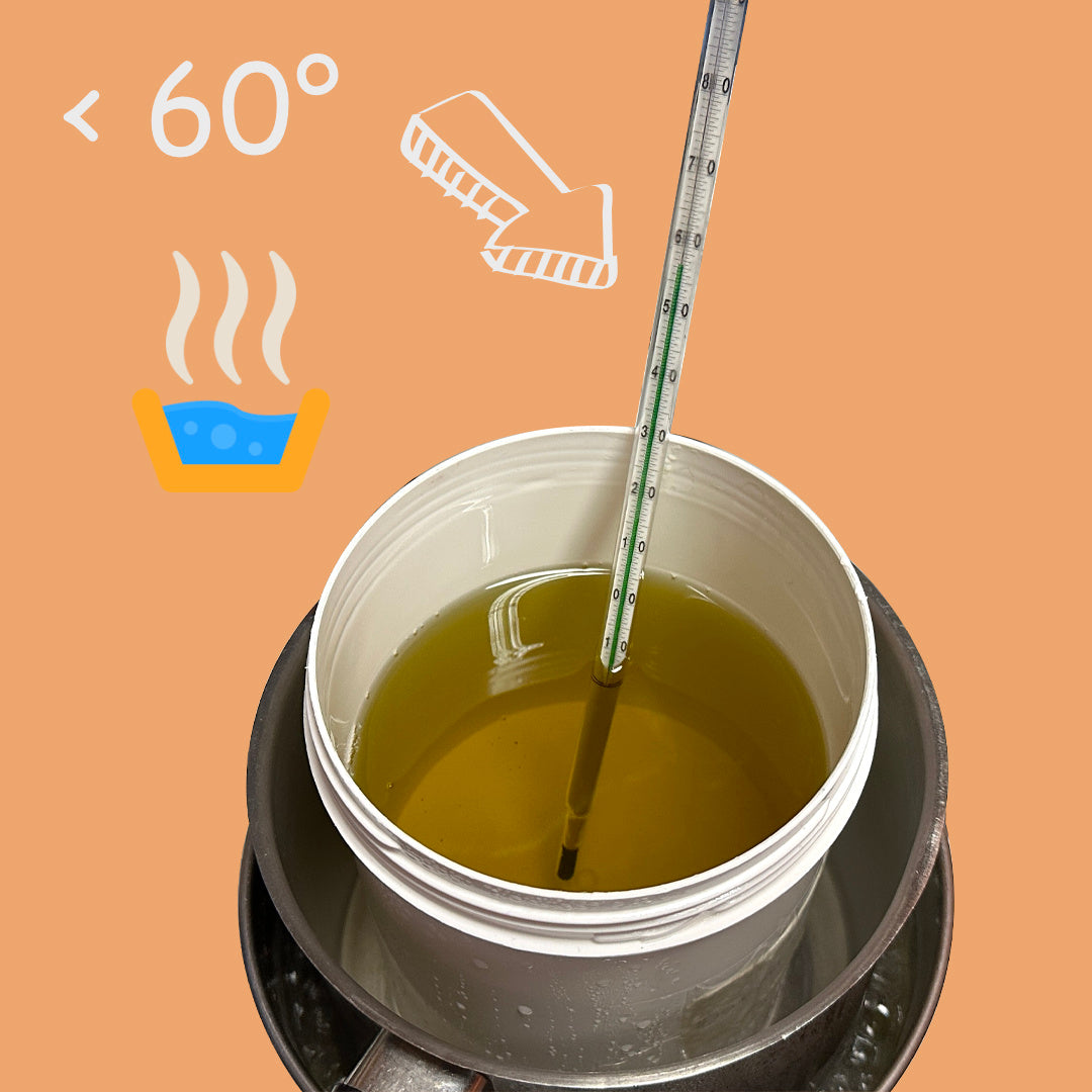 A split-screen image promoting a low-heat crafting process. On the left, black text on a white background reads: 'REASON 2 - Low Heat, High Nutrition. Discover the secret to nutrient preservation with our sub-60°C process… Our unique crafting preserves more than just ingredients—it preserves vitality.' On the right, an image shows a white container filled with a golden liquid, placed in a larger pot, with a thermometer inserted. The background is warm orange, with white illustrations of a thermometer, steam