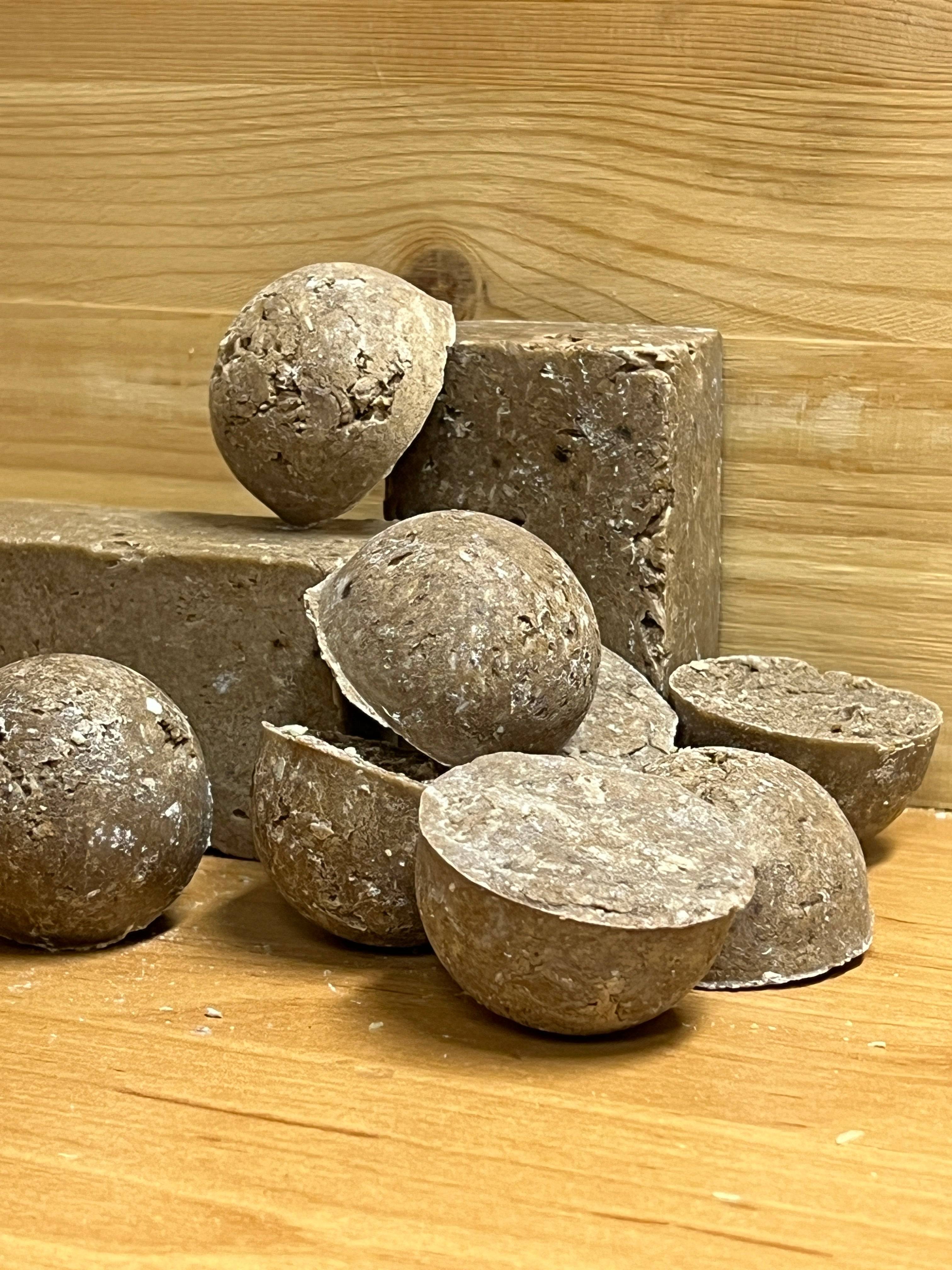 a scene showing various 'Grouda' sample solid shampoo's along with 2 full size blocks of 'Grouda'